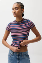 Woman wearing a striped shirt and jeans on a white background