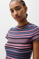 Woman wearing a striped shirt with a neutral background