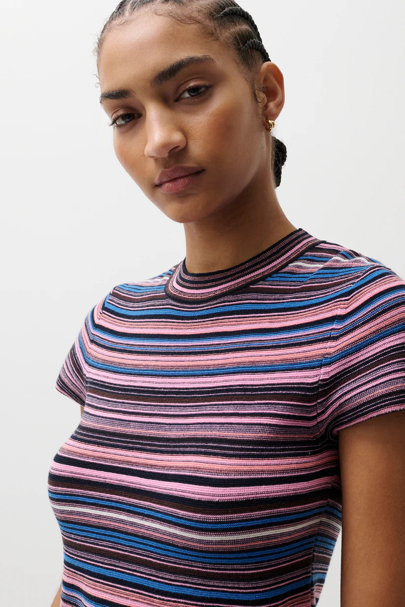 Woman wearing a striped shirt with a neutral background