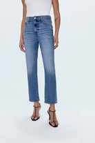 Person wearing blue jeans on a white background