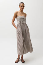 Woman wearing a striped dress on a white background