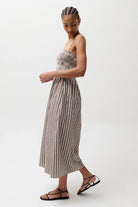 Woman wearing a striped dress on a white background