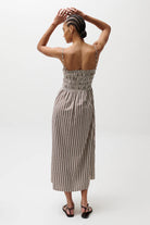 Woman wearing a striped dress on a white background