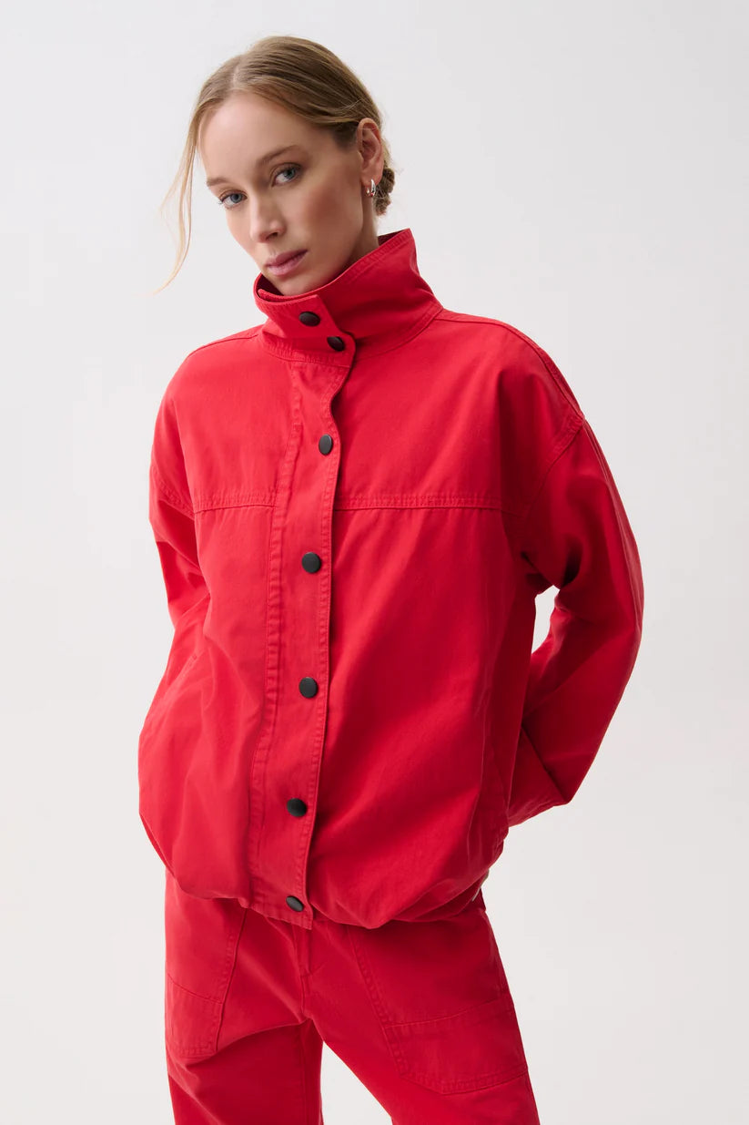 Person wearing a red outfit with black buttons on a white background