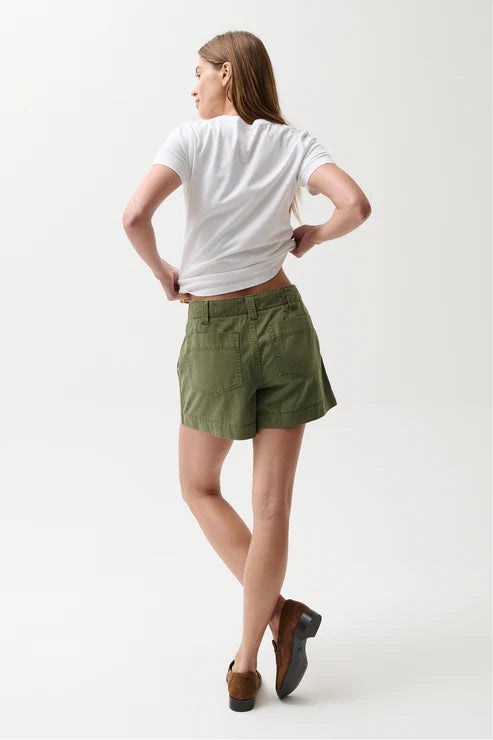 Person wearing a white t-shirt and green shorts on a white background