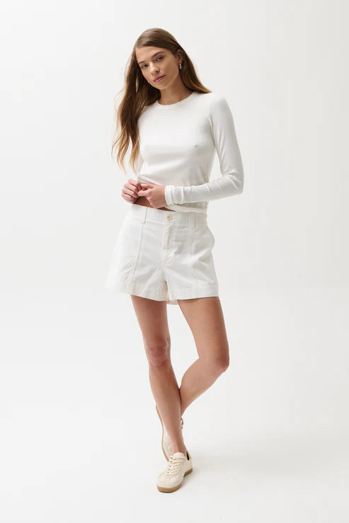 Woman wearing a white outfit on a plain background