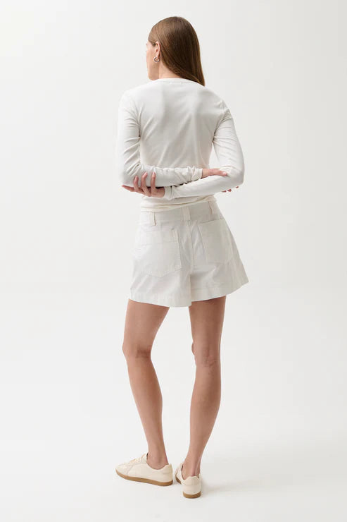 Person wearing a white outfit on a plain background