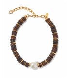 Bracelet with wooden beads and a pearl on a white background