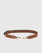Brown belt with gold hardware on a light gray background
