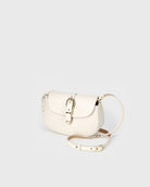 White handbag with gold accents on a light gray background