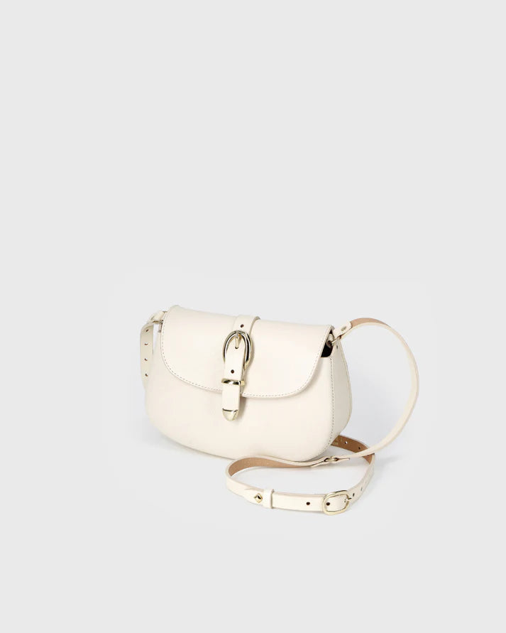 White handbag with gold accents on a light gray background