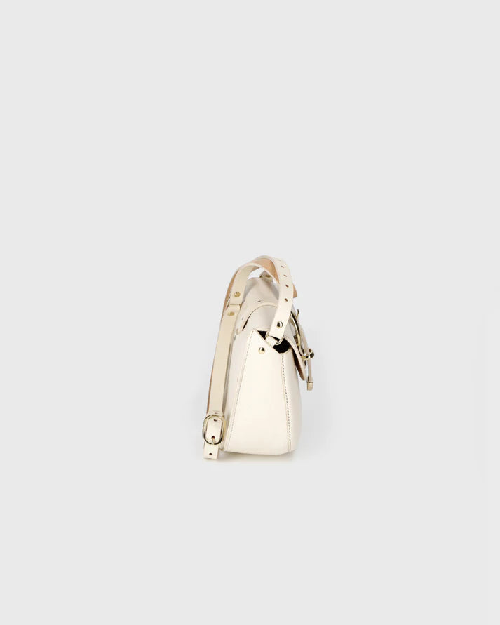 Gold ring with a heart design on a light gray background