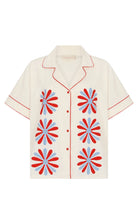 Beige shirt with red and blue floral patterns on a white background