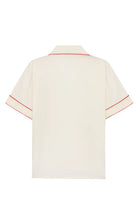 Beige shirt with red and blue floral patterns on a white background
