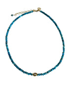 Blue beaded necklace with gold clasp on a white background