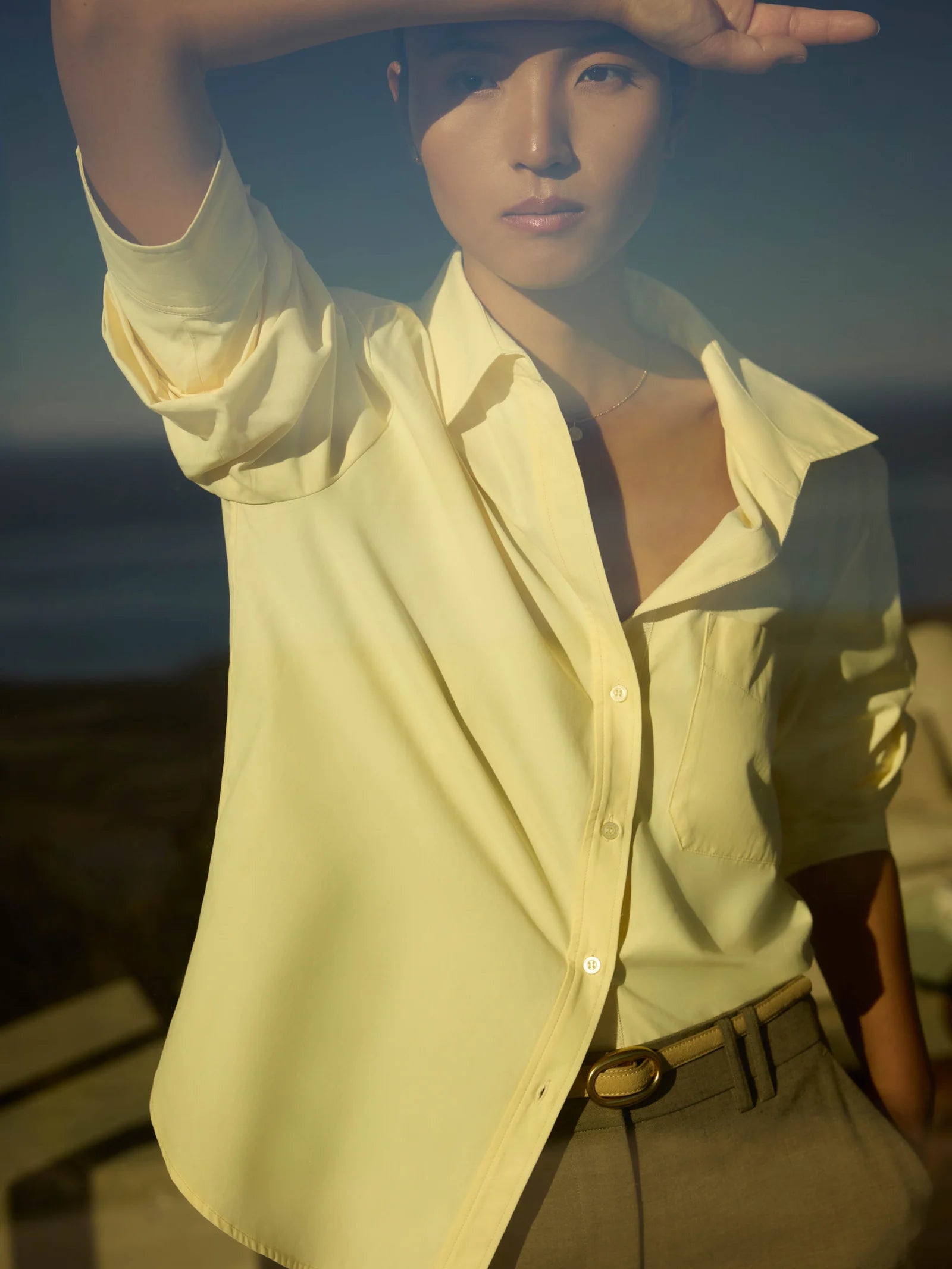 Person wearing a light-colored shirt with a blurred background