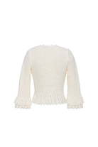 White knit cardigan with lace trim on a white background