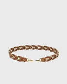 Braided leather belt with gold accents on a light gray background