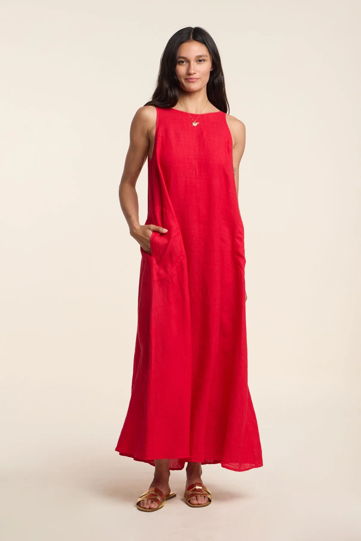 Woman wearing a red dress against a beige background