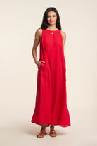 Woman wearing a red dress against a beige background