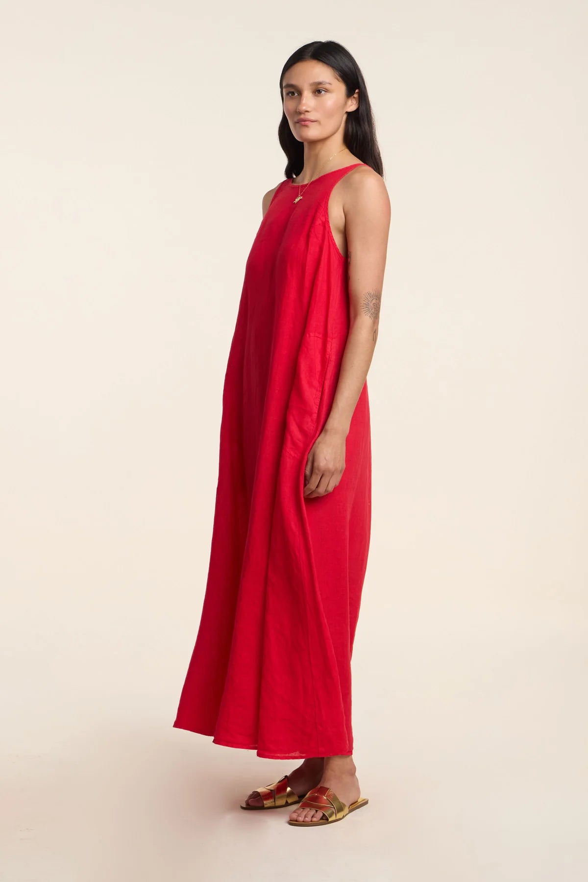 Woman wearing a red dress on a beige background