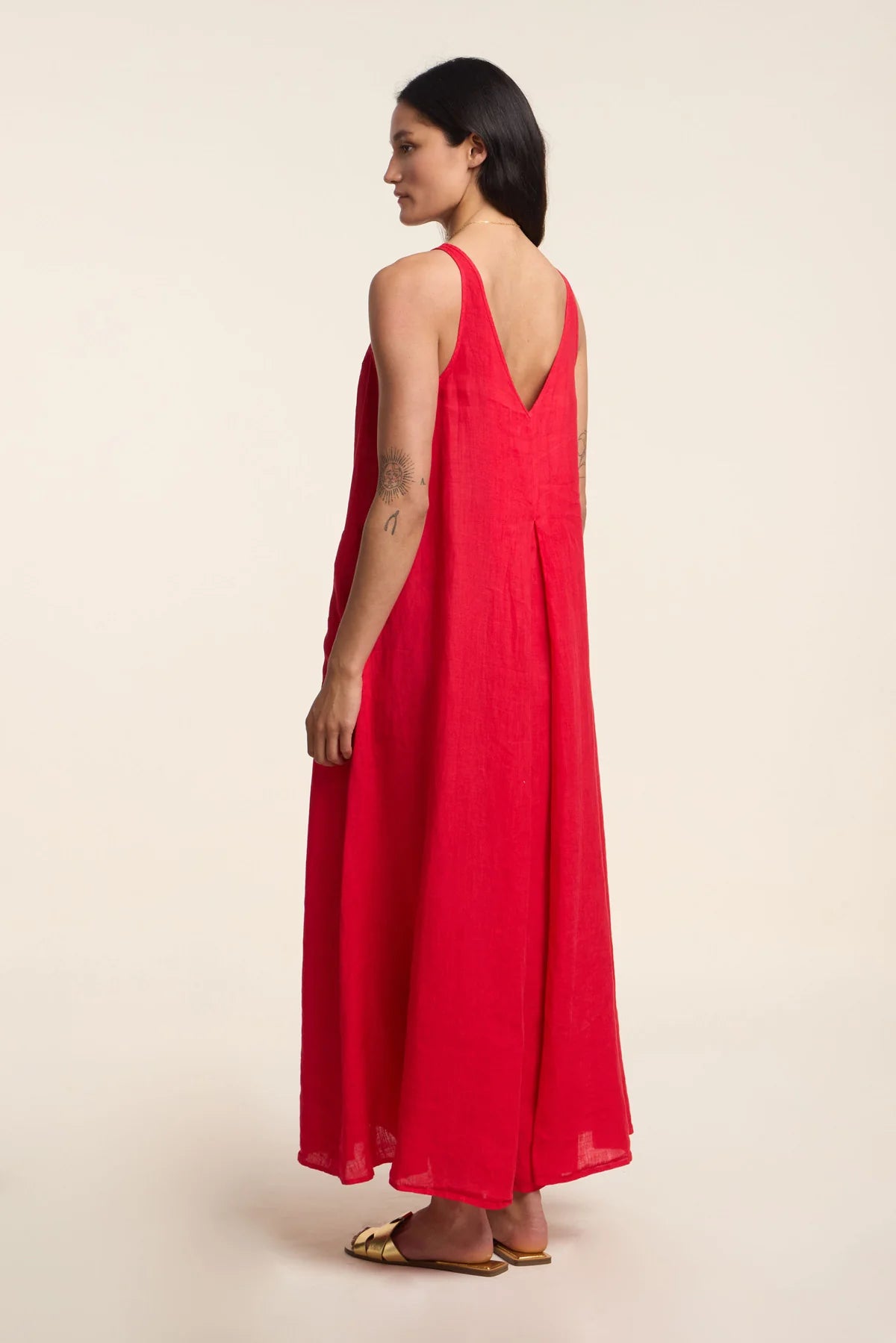 Woman wearing a red dress on a beige background