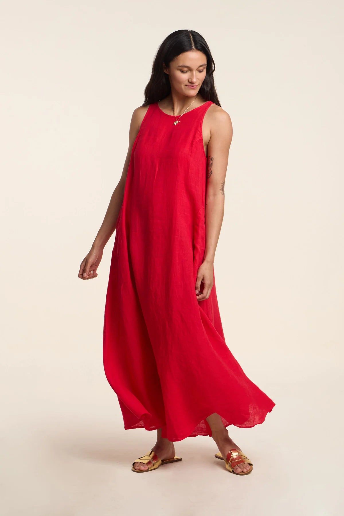 Woman wearing a red dress on a beige background