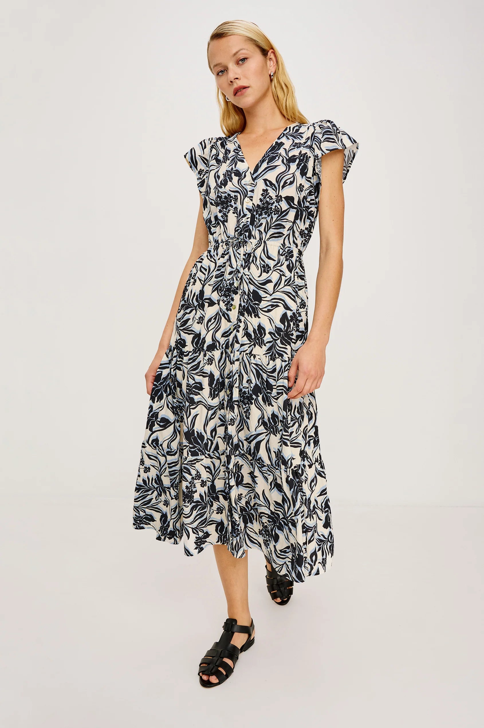 Woman wearing a black and white floral dress on a white background