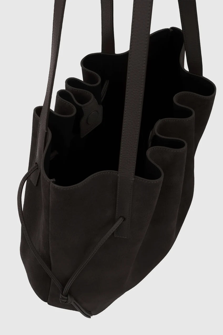 Black tote bag with ruffled design on a white background
