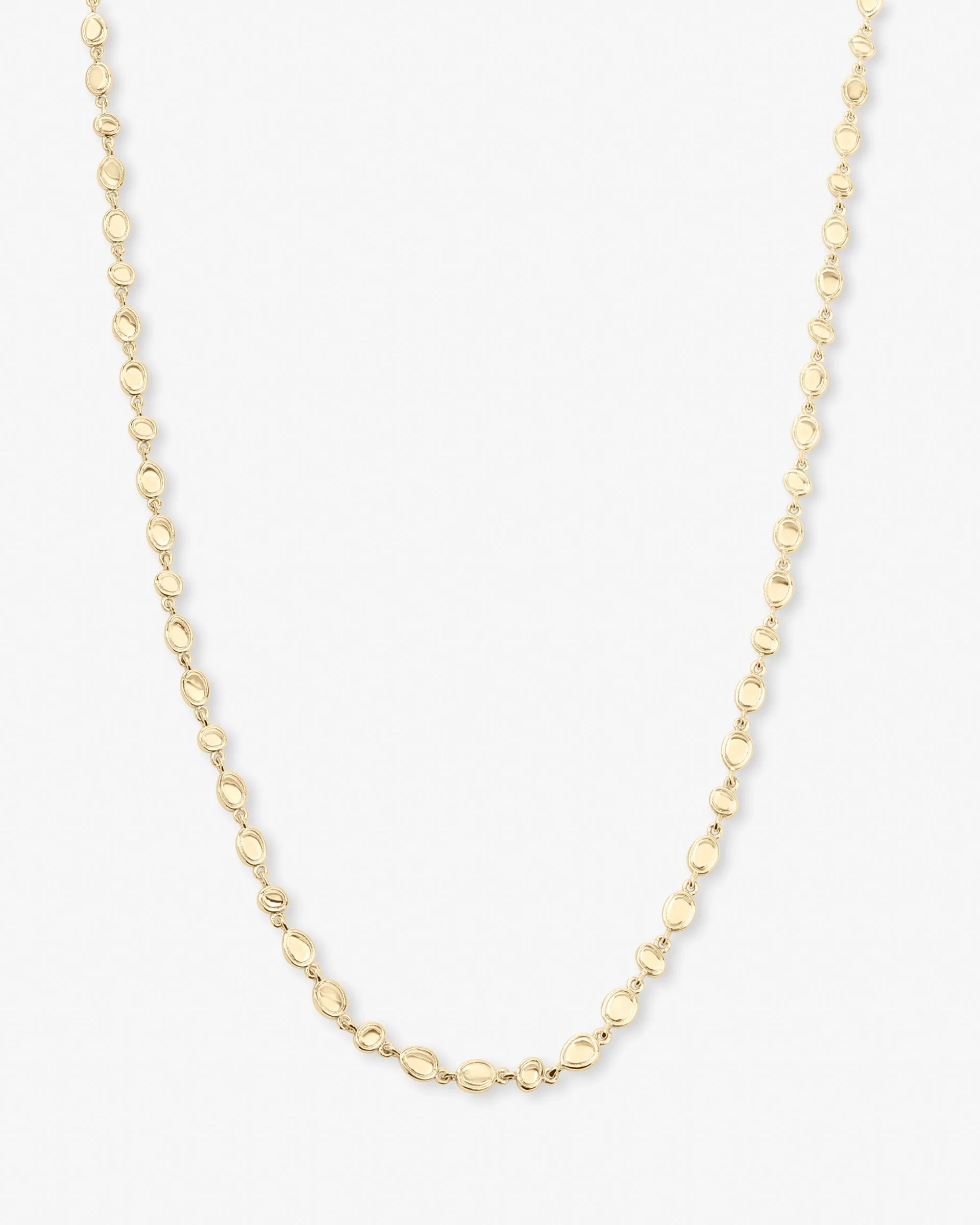 A delicate yellow gold chain necklace with small, polished oval links, displayed against a clean white background.