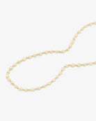 A delicate gold chain necklace with elongated oval links, arranged in a loose curve on a clean white background.