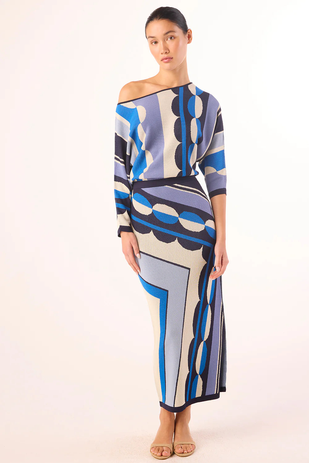 Woman wearing a patterned dress on a white background