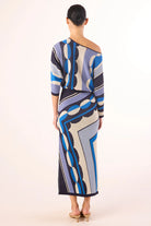 Woman wearing a patterned dress on a white background