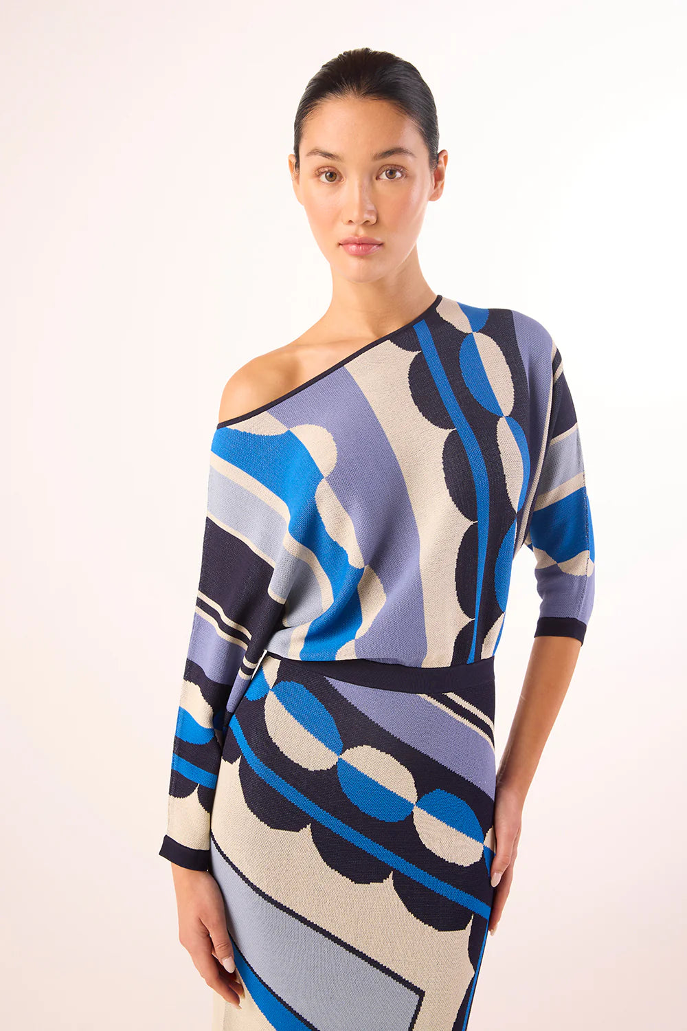 Woman wearing a patterned dress on a white background