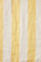 Fabric with yellow and white vertical stripes on a textured background