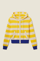 Yellow and white striped hoodie with blue accents on a beige background