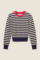 Navy and white striped sweater with red neckline on a beige background