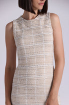 Beige sleeveless dress worn by a model on a white background