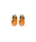 Pair of orange earrings with gold tops on a white background