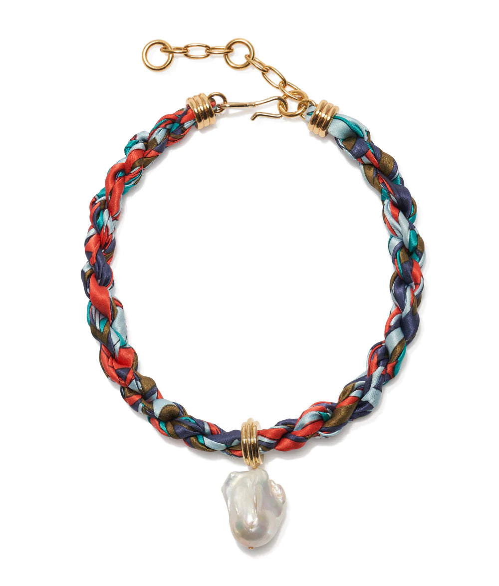 Multicolored braided bracelet with a pearl pendant on a white background