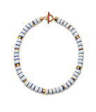 Bracelet with white and blue striped beads and gold accents on a white background