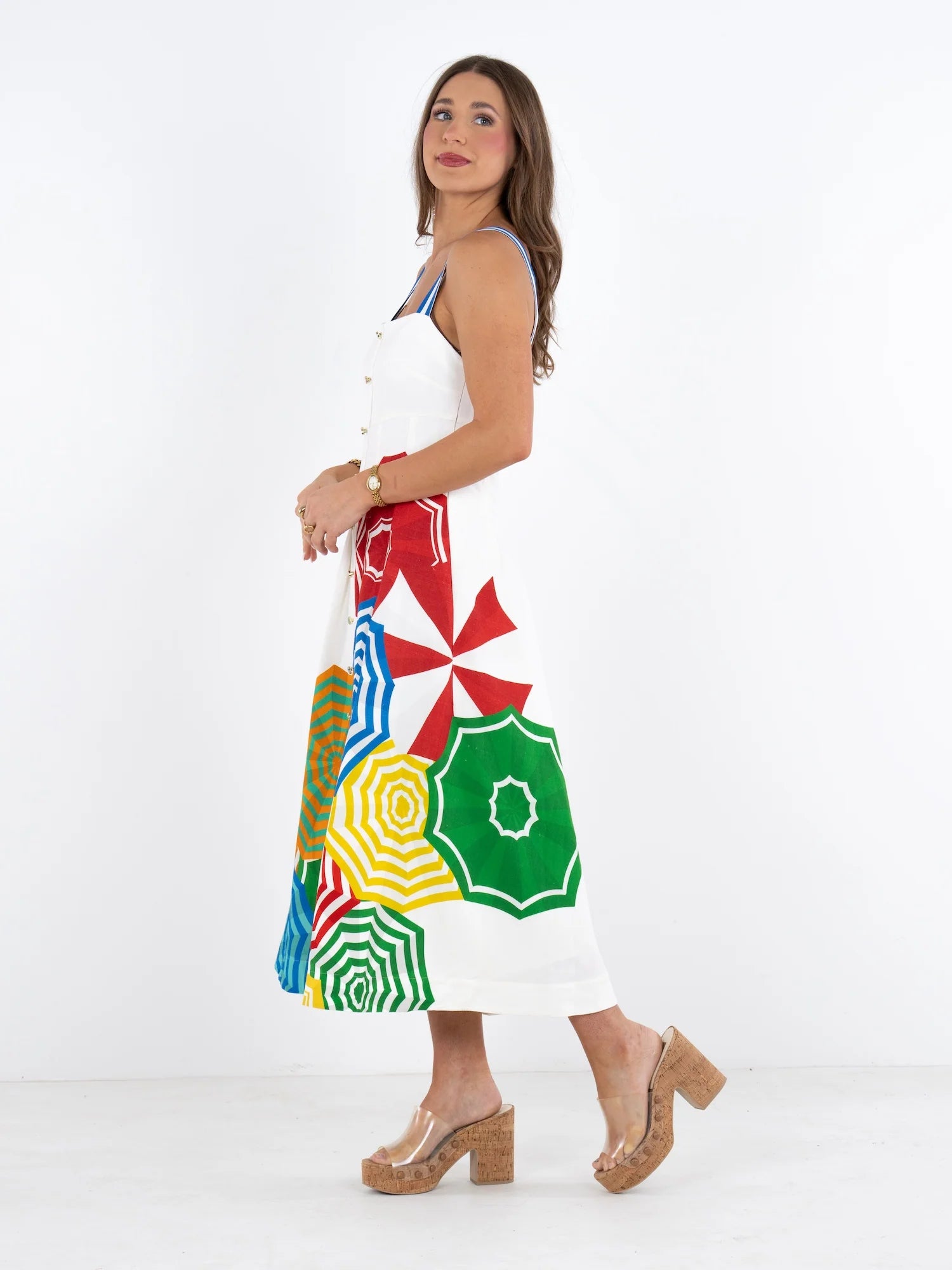 Woman wearing a colorful skirt with geometric patterns on a white background