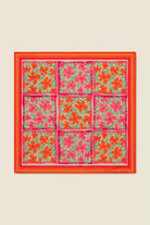 Floral patterned fabric with a red border on a beige background