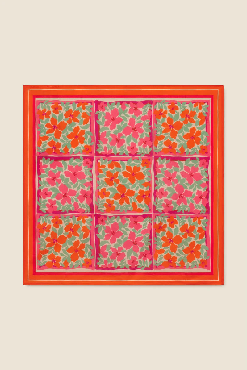 Floral patterned fabric with a red border on a beige background