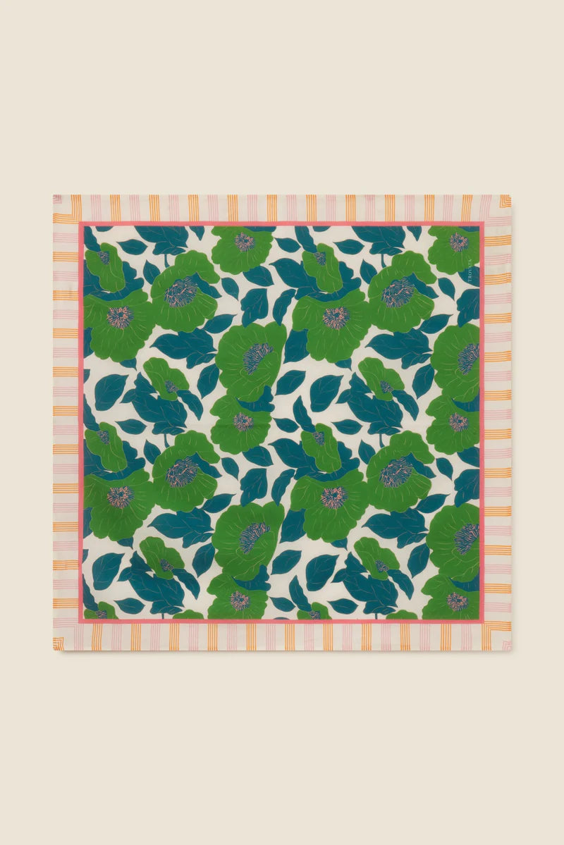 Floral patterned fabric with green and blue flowers on a beige background