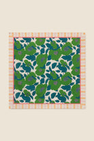 Floral patterned fabric with green and blue flowers on a beige background