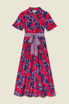 Colorful floral dress with a belt on a beige background