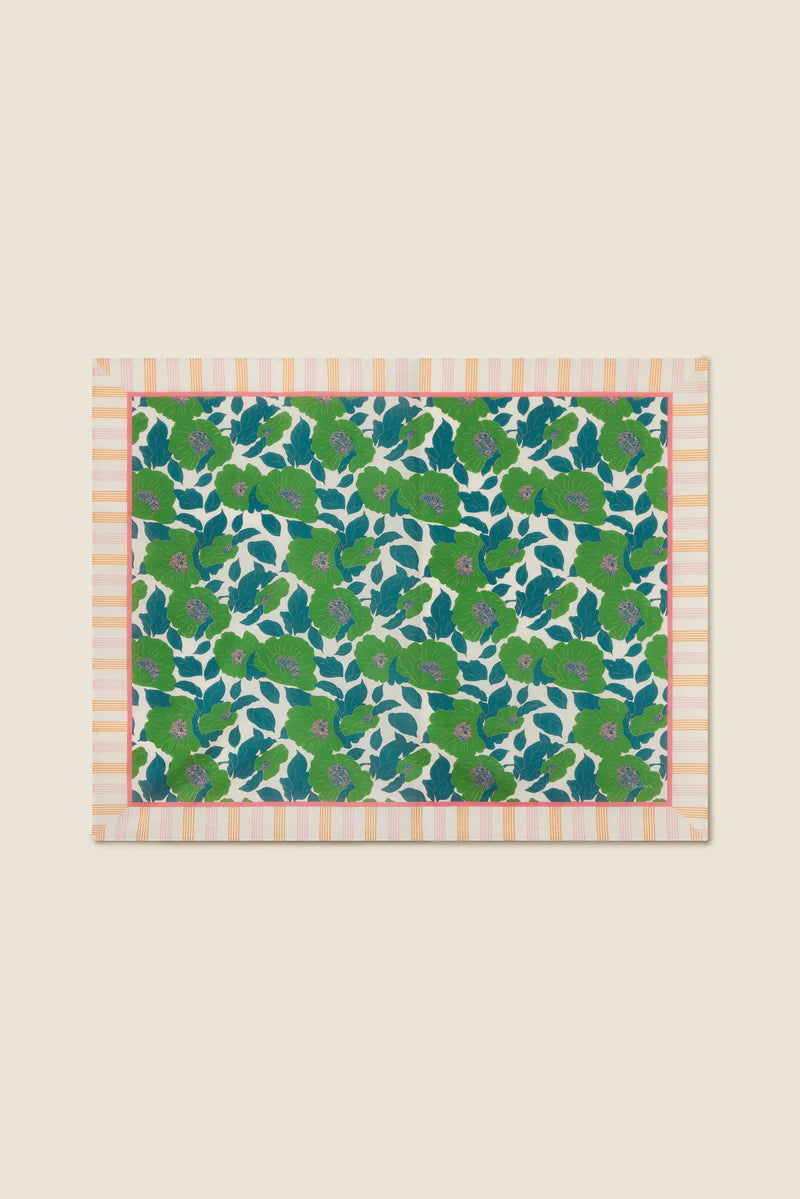 Fabric swatch with green floral pattern on a beige background