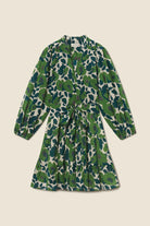 Green floral dress on a beige background