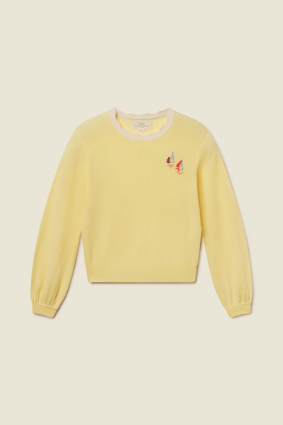 Yellow sweater with a small design on a beige background